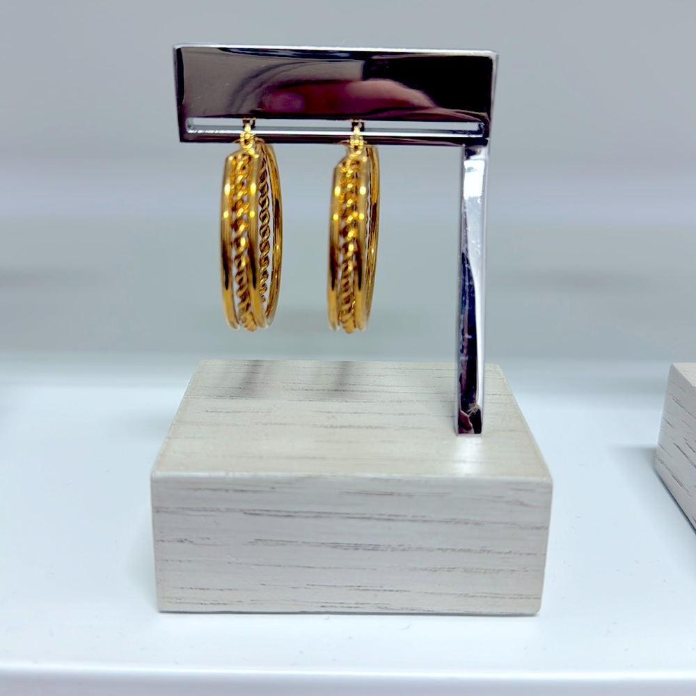 Gold hoop earrings, by @__strand__